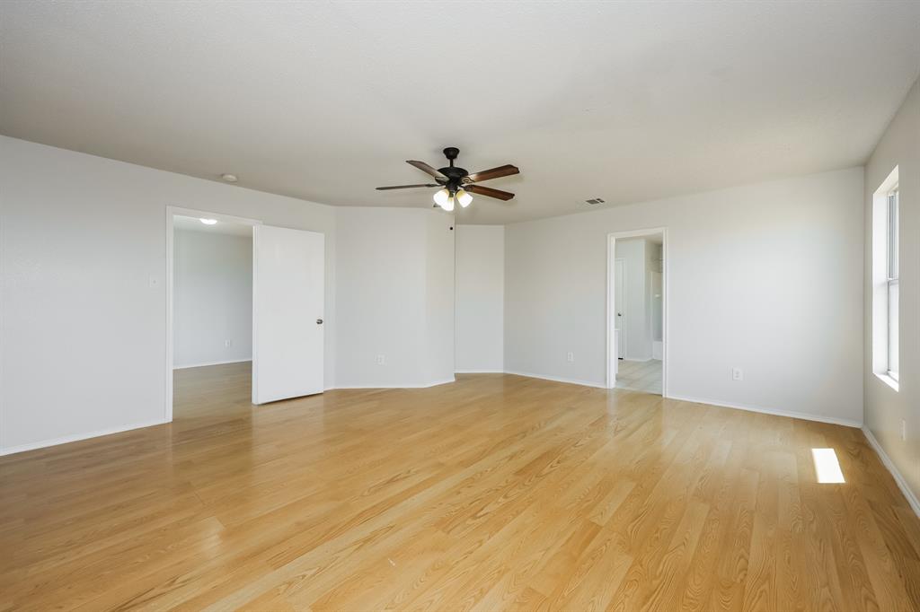 312 Dakota Ridge Drive Fort Worth, TX 76134 - Photo 10 of 15 a view of an empty room and chandelier fan