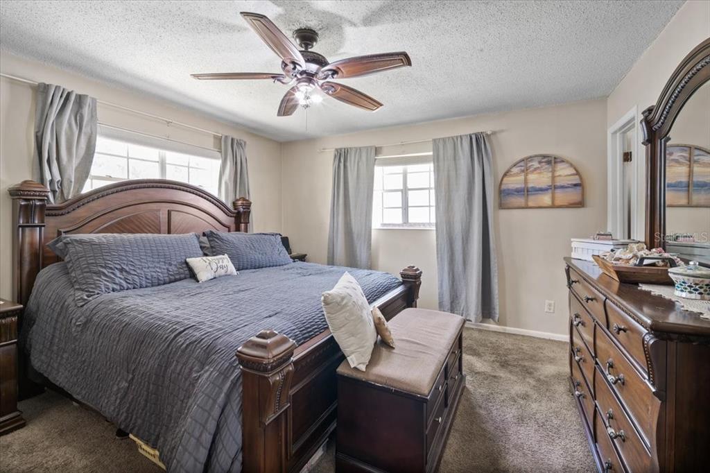 7422 County Road 231 Lake Butler, FL 32054 - Photo 26 of 57 a bedroom with a bed and a chandelier