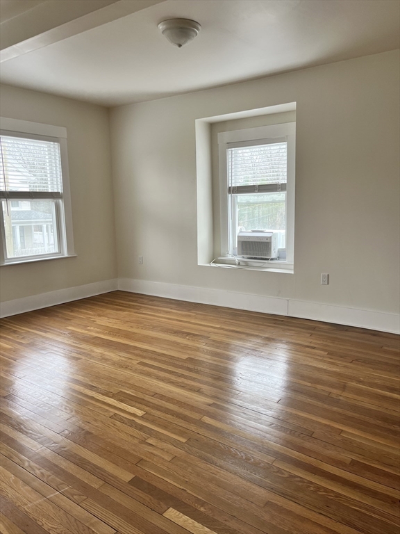 17 Linden Place, Unit 2 Dedham, MA 02026 - Photo 5 of 9 an empty room with wooden floor and windows