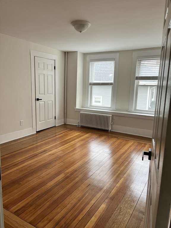 17 Linden Place, Unit 2 Dedham, MA 02026 - Photo 6 of 9 wooden floor in an empty room with a window