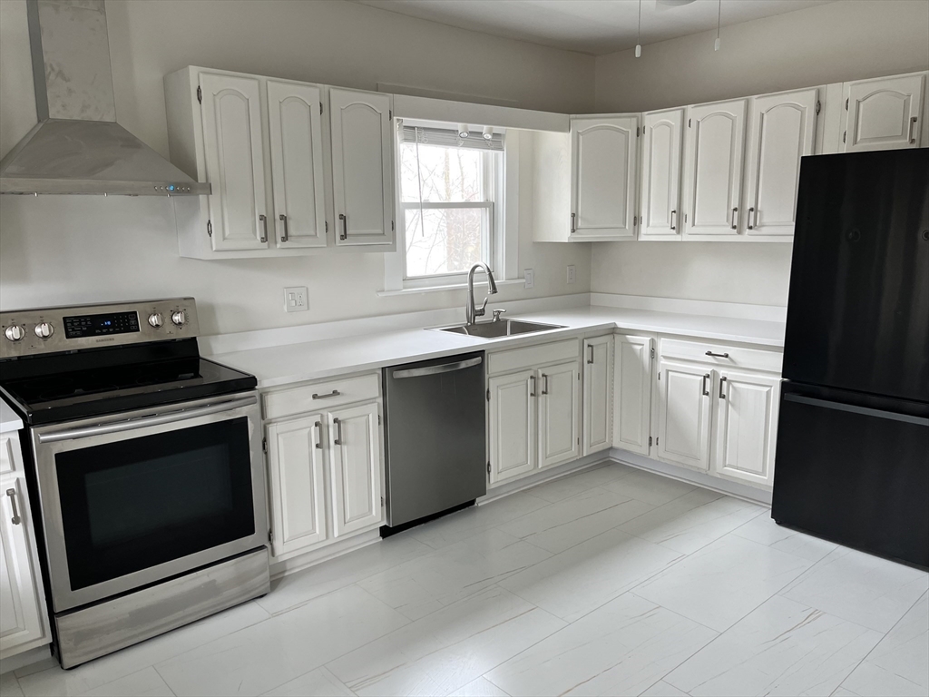 17 Linden Place, Unit 2 Dedham, MA 02026 - Photo 7 of 9 a kitchen with cabinets appliances and a sink