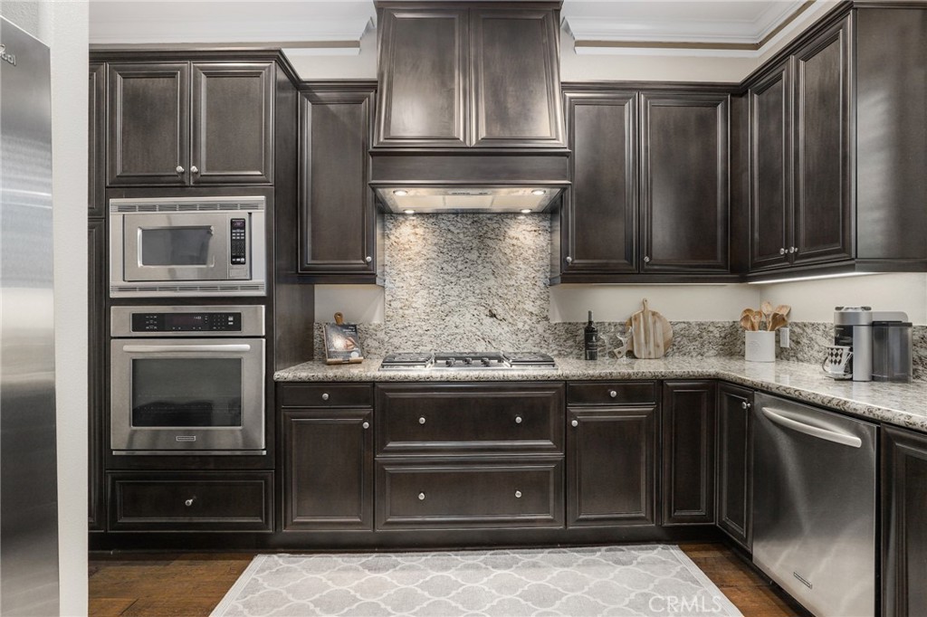 a kitchen with granite countertop stainless steel appliances and cabinets