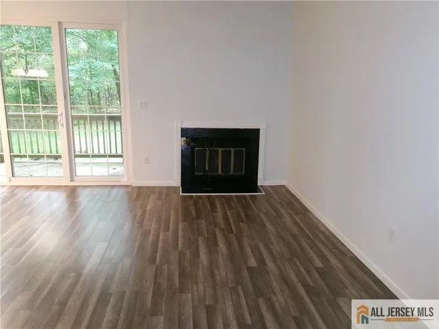 a view of an empty room and wooden floor