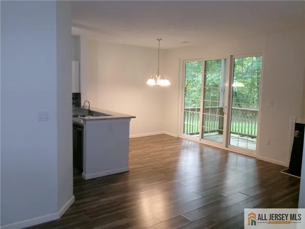 a view of a kitchen with wooden floor and a floor to ceiling window