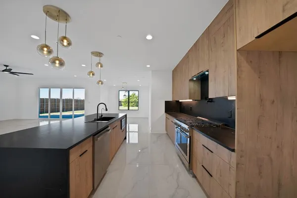 a kitchen with stainless steel appliances granite countertop a sink and stove