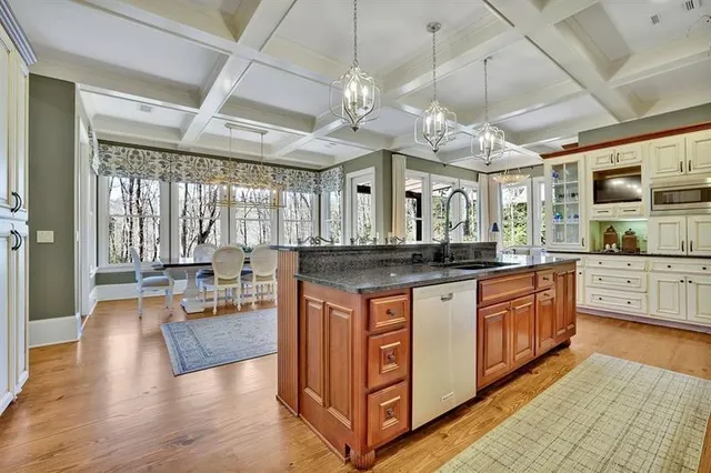 a kitchen with stainless steel appliances granite countertop a sink and cabinets