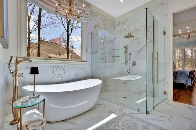 a bathroom with a sink and mirror with bathtub