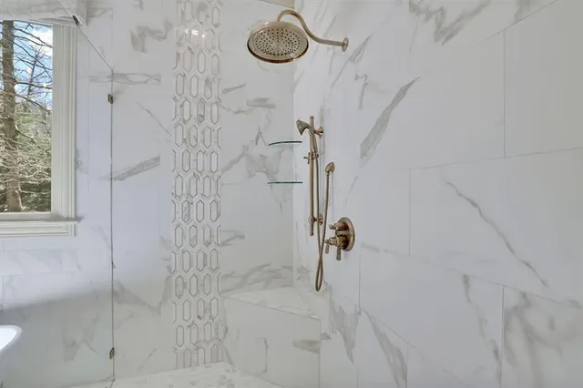 a living room with furniture kitchen view and a wooden floor