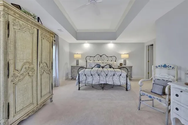 a bedroom with a bed couch and a window