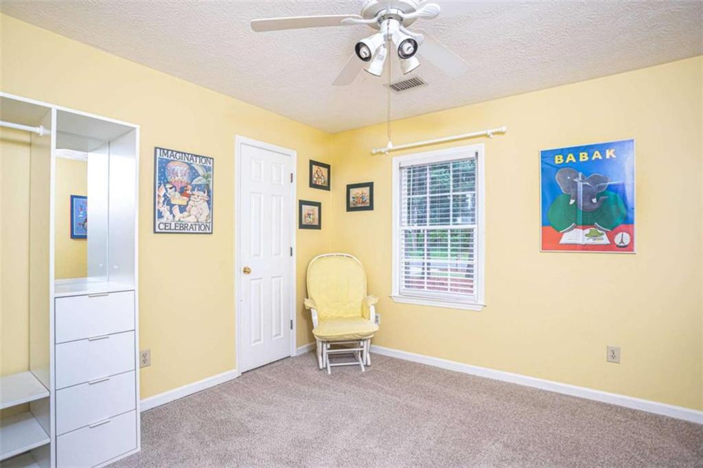 3838 Hunting Ridge Drive Southwest Lilburn, GA 30047 - Photo 34 of 56 a view of a bedroom with window and furniture