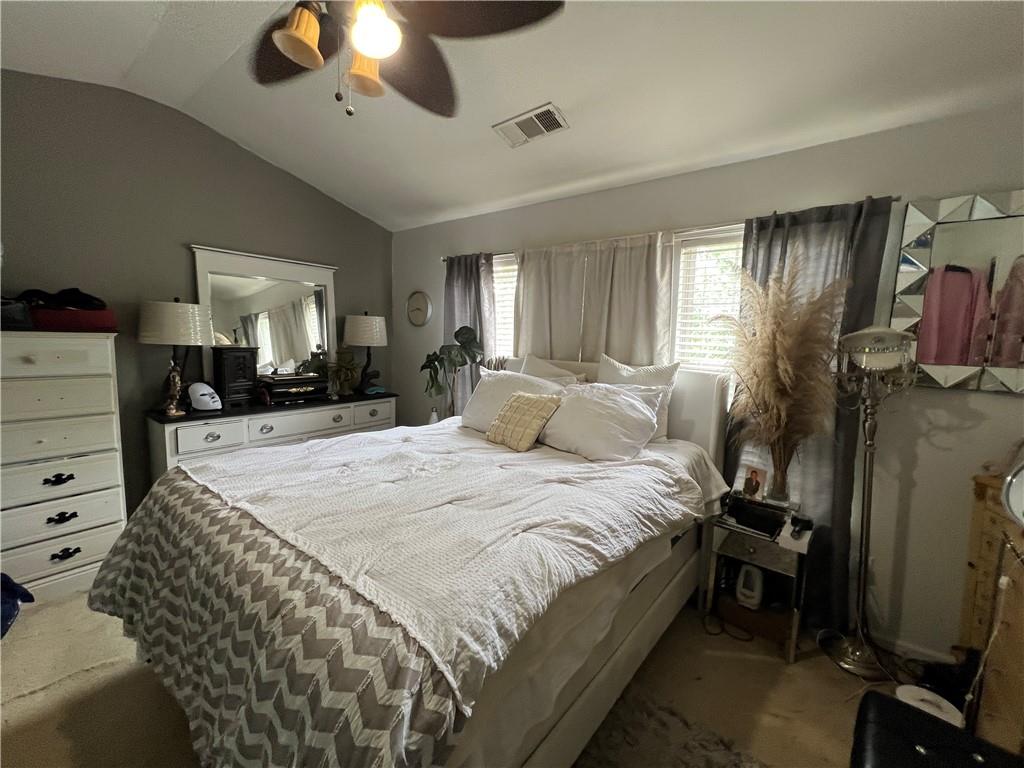 3914 Howell Park Road Duluth, GA 30096 - Photo 14 of 33 a spacious bedroom with a bed and a chandelier