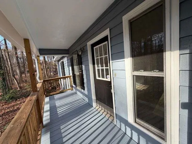 a view of balcony with wooden floor