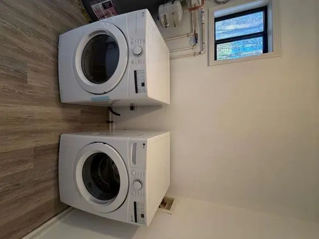 a close view of a utility room with dryer and washer