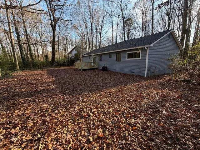 a view of house with backyard