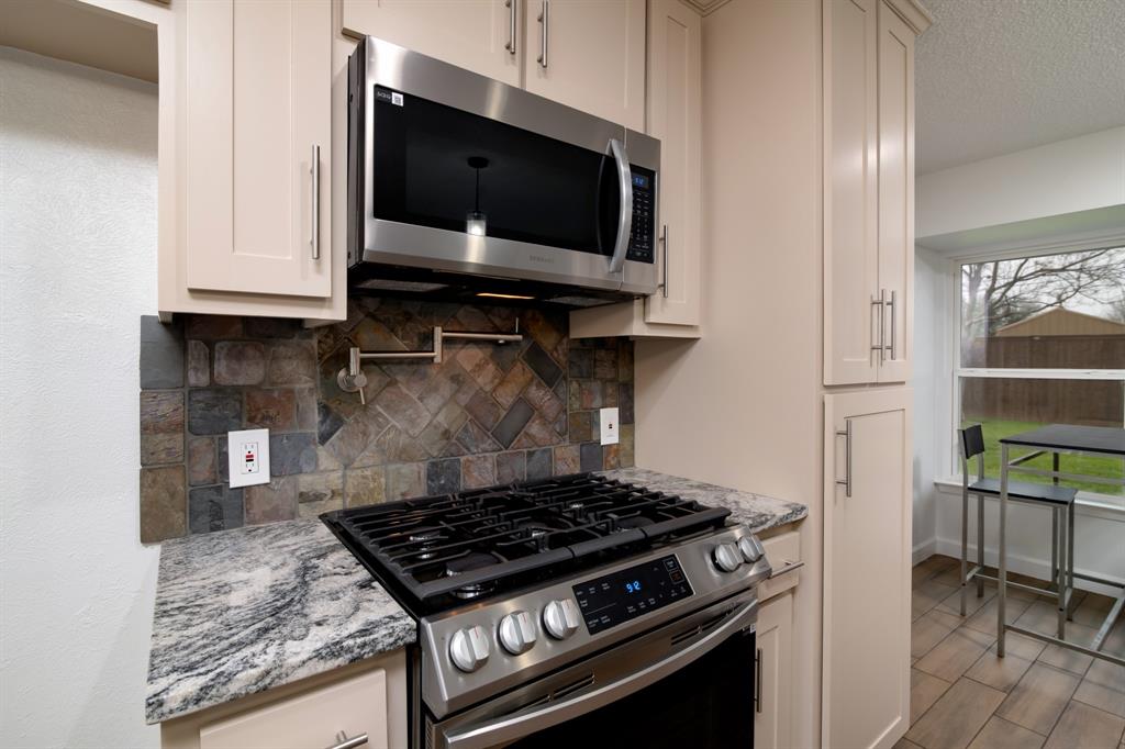 a kitchen with microwave a stove and a cabinets