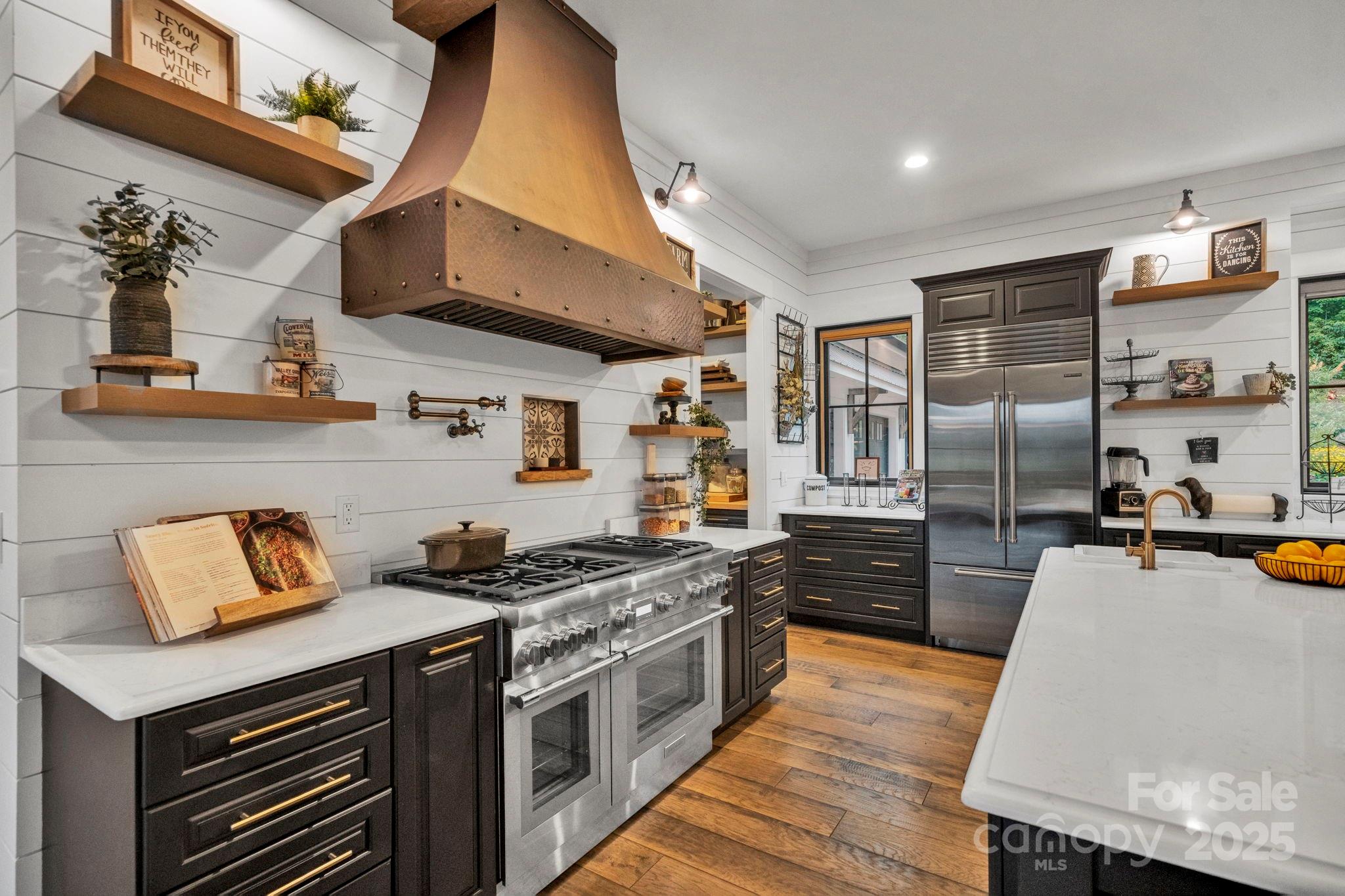 23 Windy Ridge Fairview, NC 28730 - Photo 12 of 47 a kitchen with stainless steel appliances granite countertop a stove a sink and a refrigerator