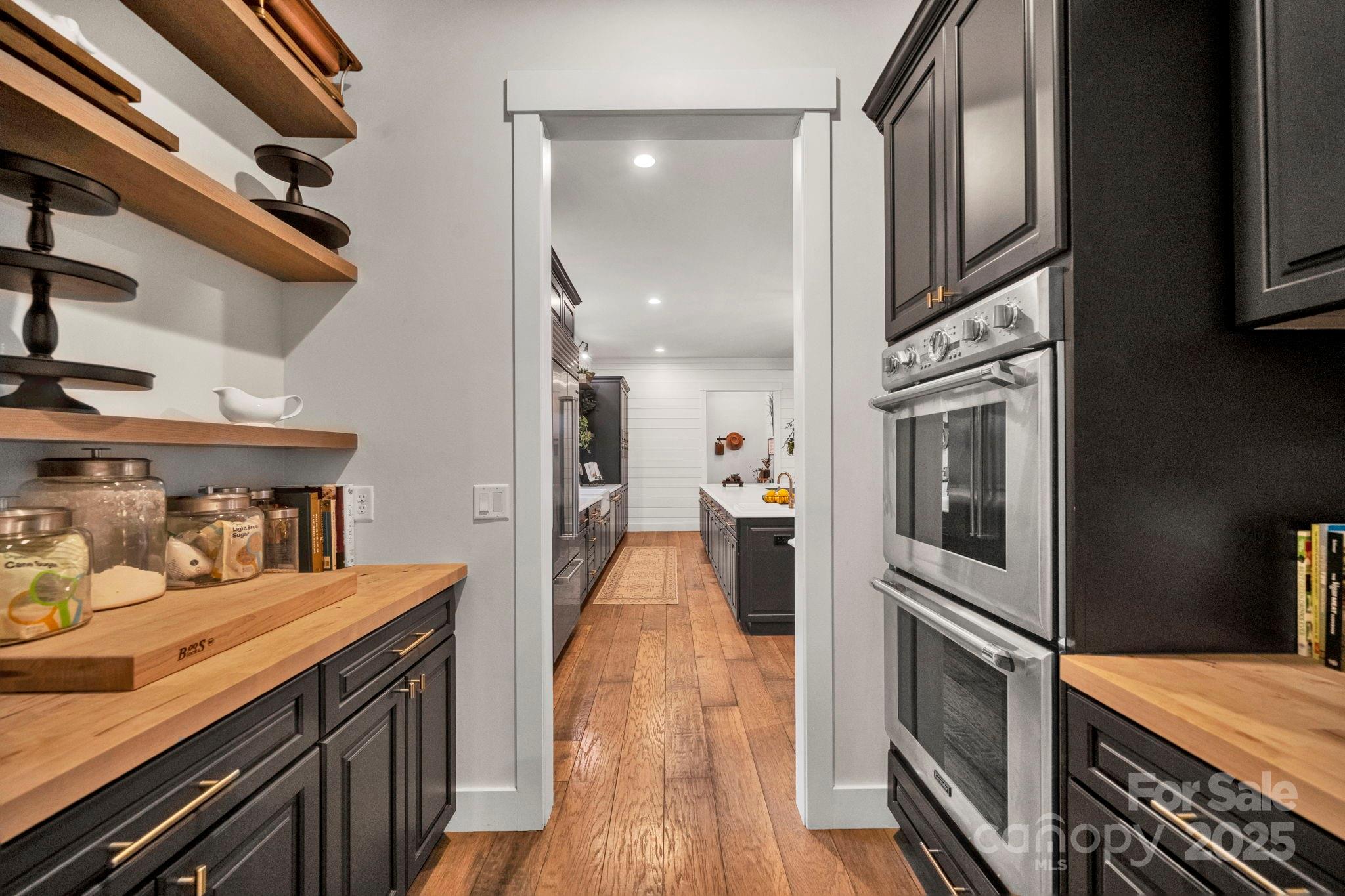 23 Windy Ridge Fairview, NC 28730 - Photo 14 of 47 a kitchen with stainless steel appliances granite countertop a refrigerator a stove and a wooden floors