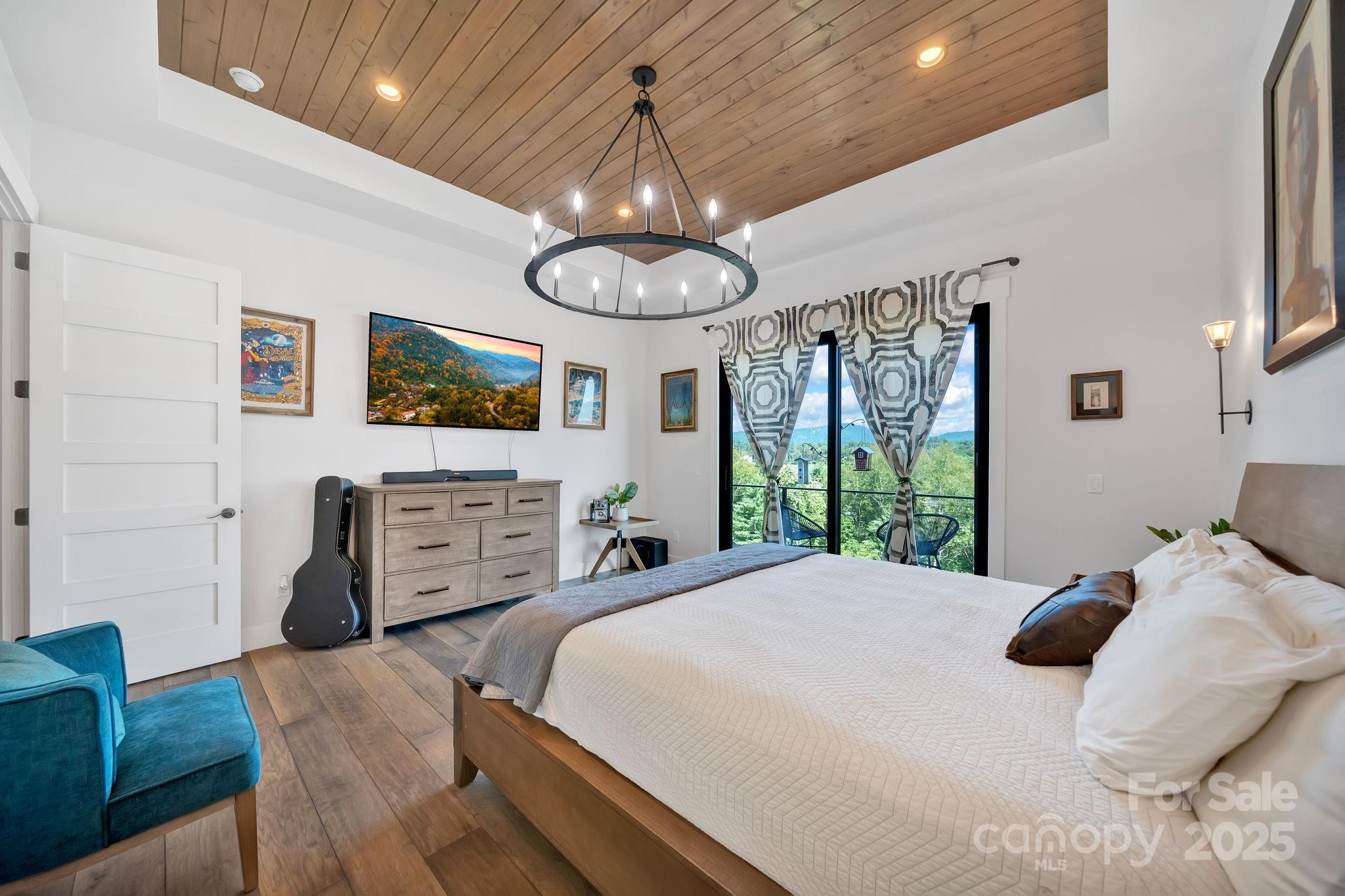 23 Windy Ridge Fairview, NC 28730 - Photo 16 of 47 a bedroom with a bed and ceiling fan