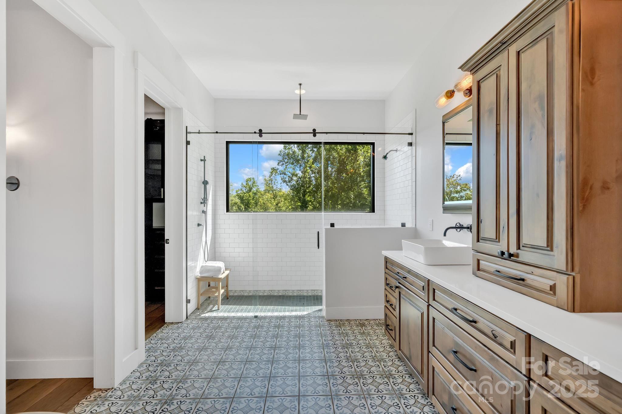 23 Windy Ridge Fairview, NC 28730 - Photo 17 of 47 a bathroom with a sink a toilet and a mirror