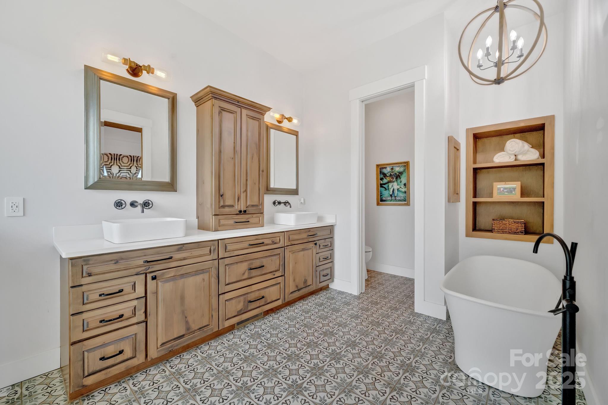 23 Windy Ridge Fairview, NC 28730 - Photo 19 of 47 a spacious bathroom with a tub sink and mirror