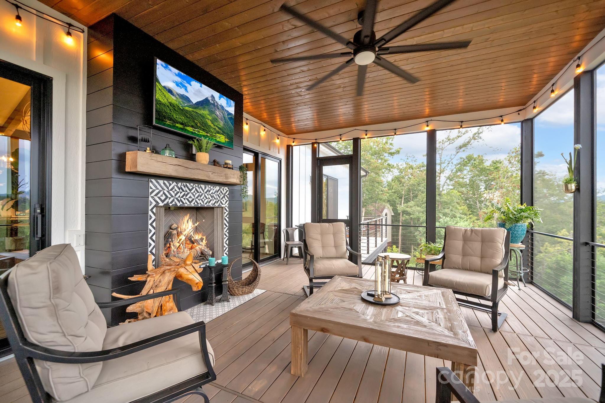 23 Windy Ridge Fairview, NC 28730 - Photo 28 of 47 a living room with furniture a flat screen tv and a fireplace
