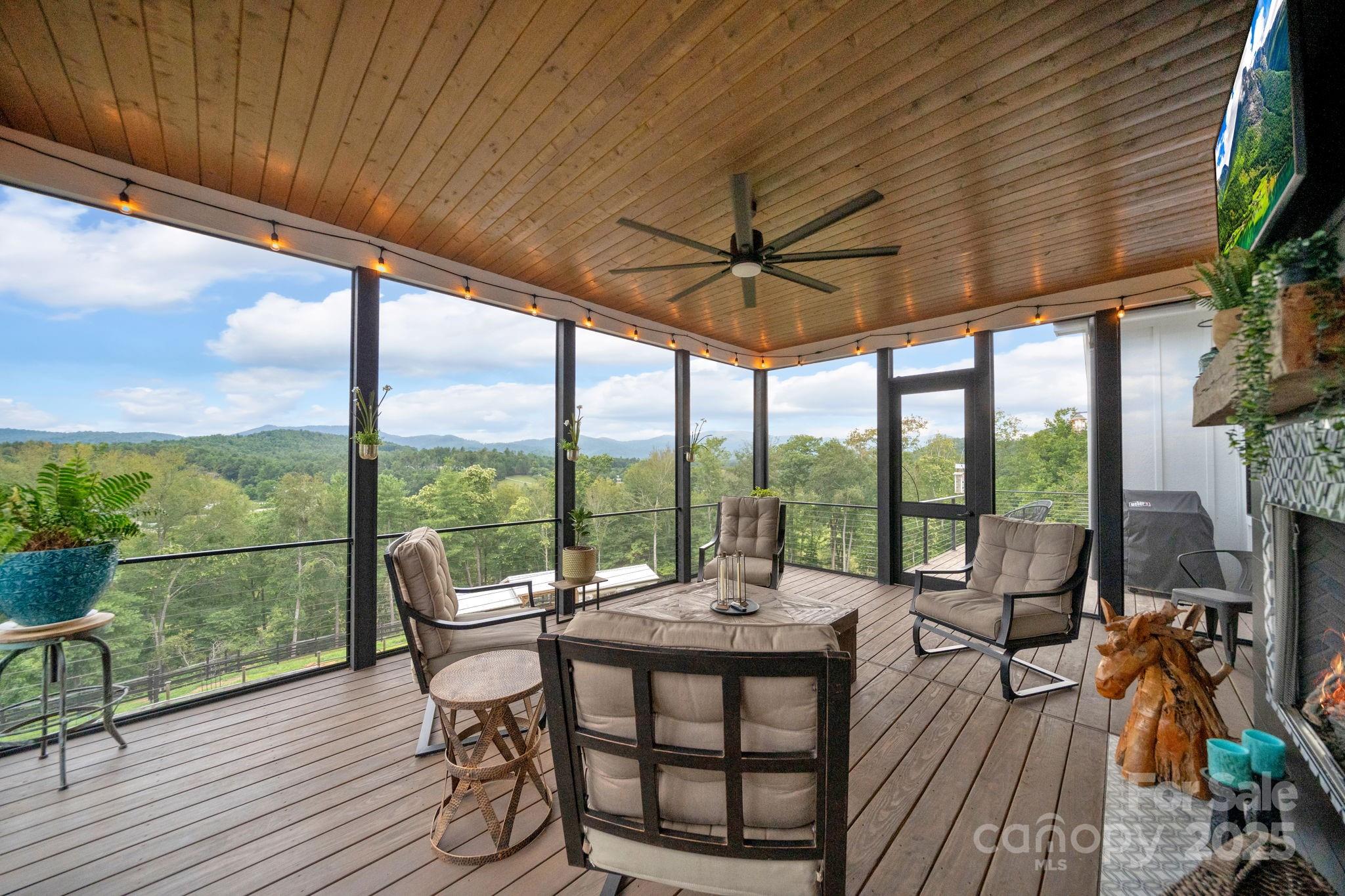 23 Windy Ridge Fairview, NC 28730 - Photo 29 of 47 a living room with furniture and a floor to ceiling window