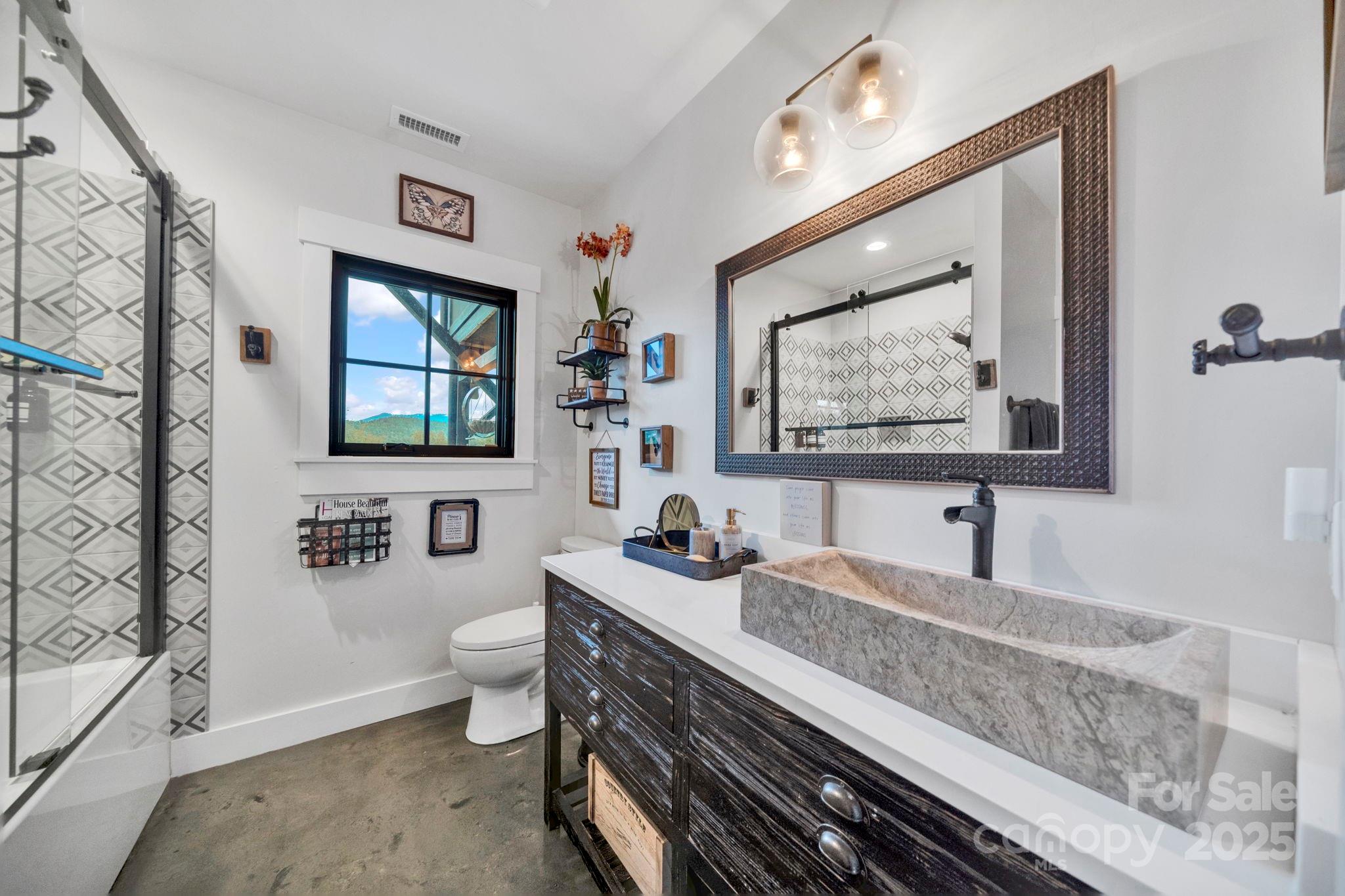 23 Windy Ridge Fairview, NC 28730 - Photo 34 of 47 a bathroom with a sink mirror and toilet