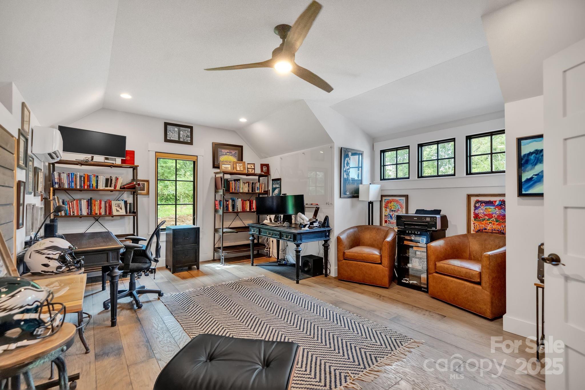 23 Windy Ridge Fairview, NC 28730 - Photo 45 of 47 a living room with furniture a flat screen tv and a book shelf
