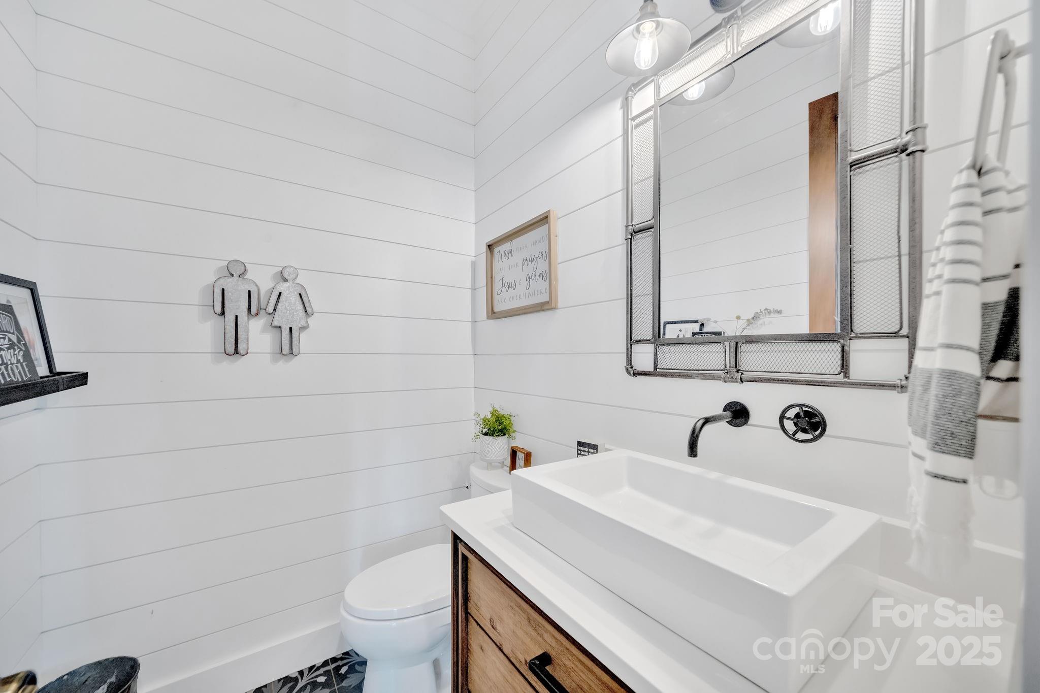 23 Windy Ridge Fairview, NC 28730 - Photo 46 of 47 a bathroom with a sink a toilet and mirror