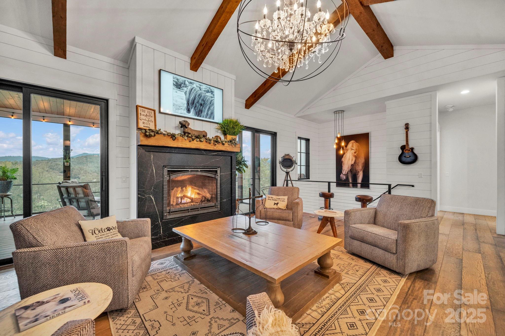 23 Windy Ridge Fairview, NC 28730 - Photo 9 of 47 a living room with furniture a fireplace and a flat screen tv