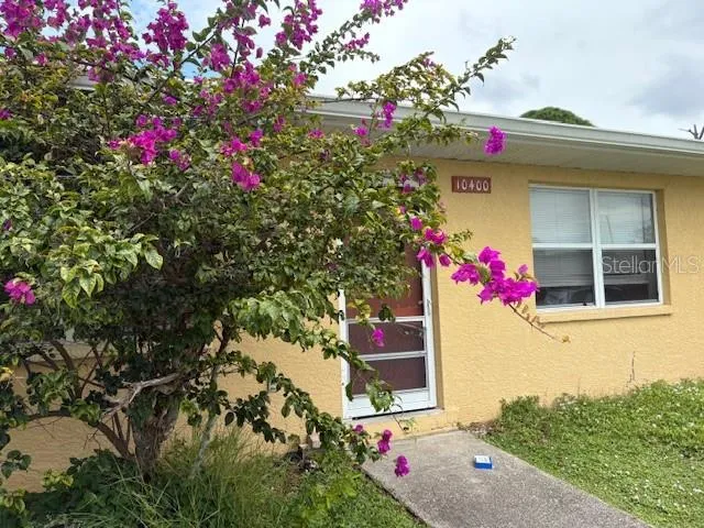 a front view of a house with fountain