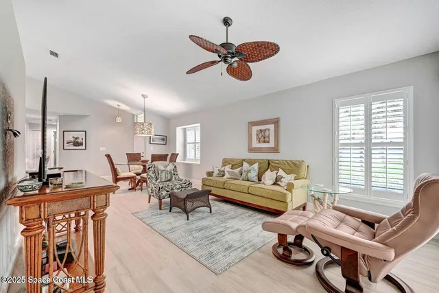 a living room with furniture gym equipment and a large window