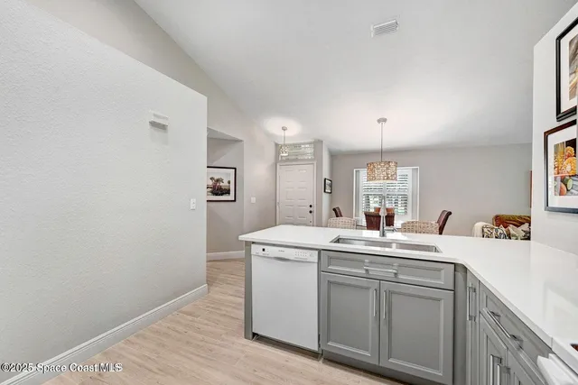 a utility room with sink dryer and washer