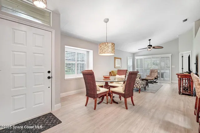 a dining room with furniture window and wooden floor