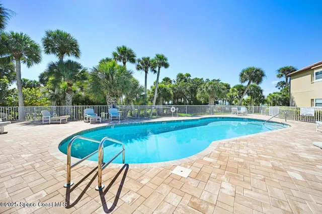 a view of a swimming pool with a lounge chair
