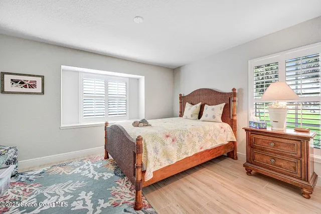 a bedroom with a bed a window and dresser