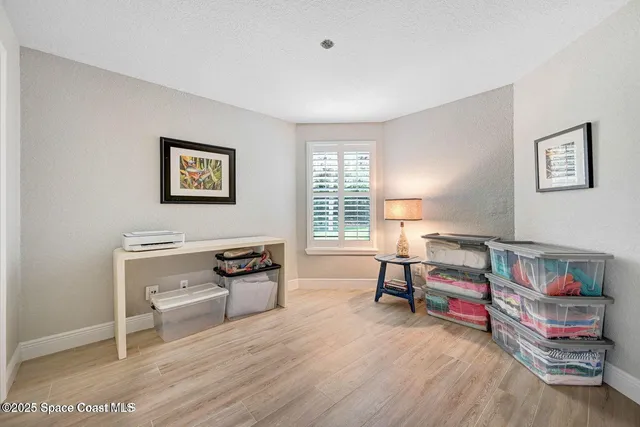 a bedroom with furniture and a wooden floor