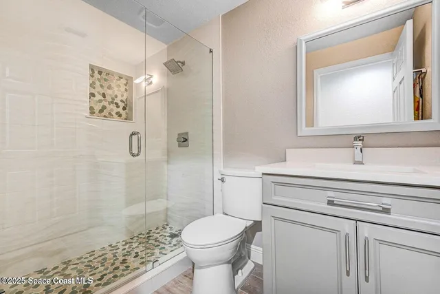 a bathroom with a sink toilet and shower