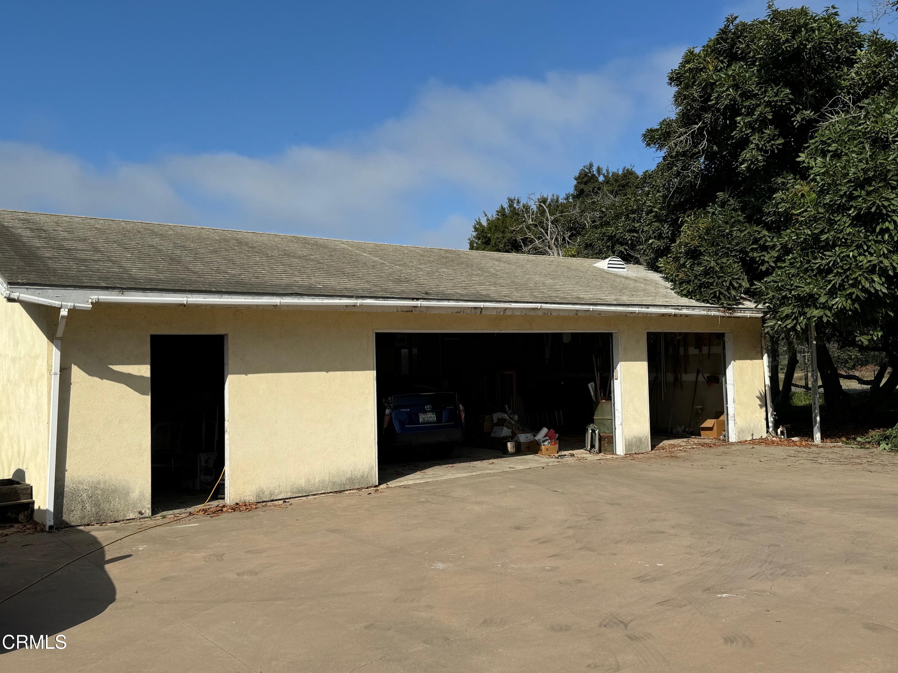 284 East Collins Street Oxnard, CA 93036 - Photo 15 of 18 a view of a house with a yard and garage