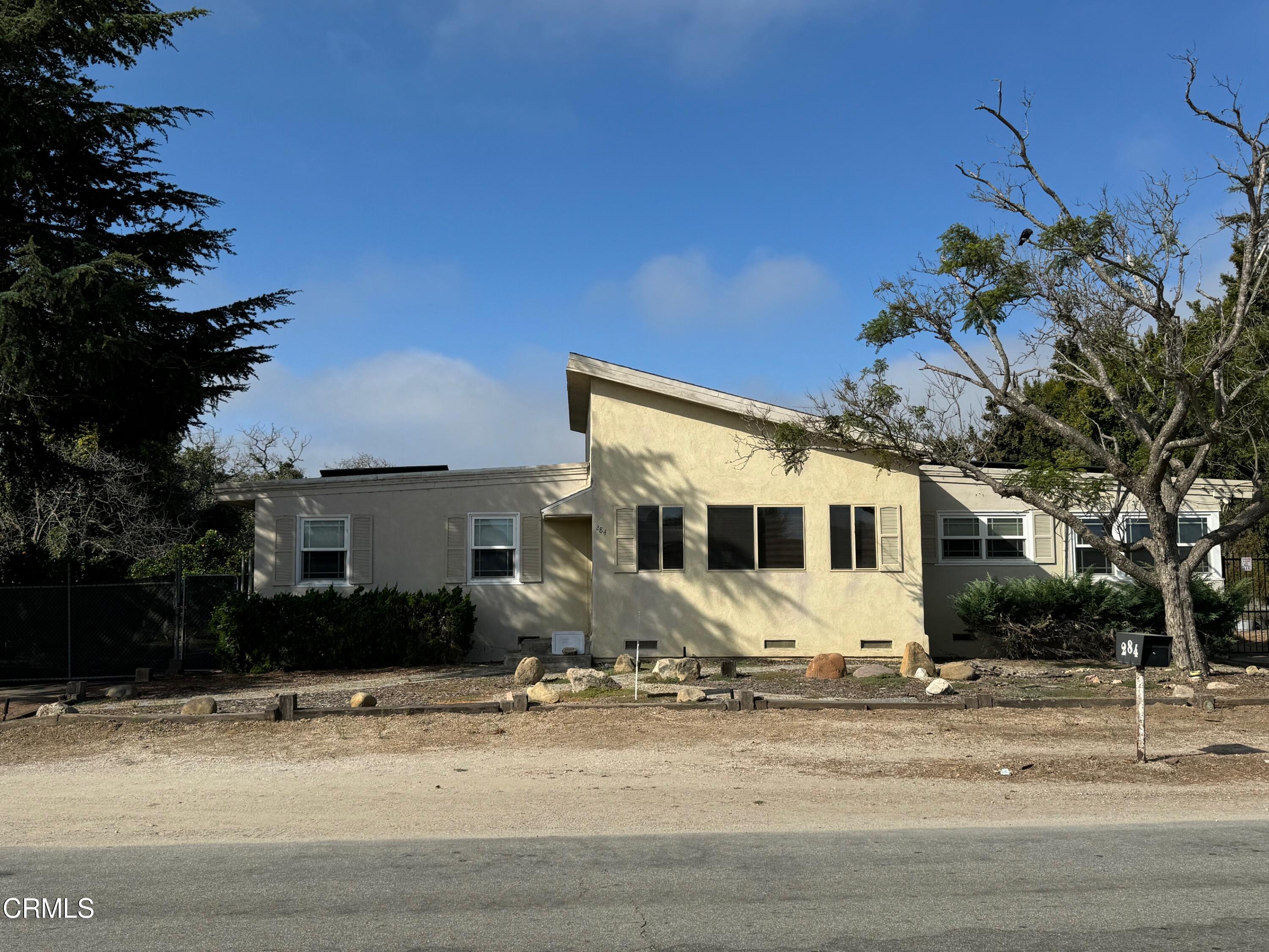 284 East Collins Street Oxnard, CA 93036 - Photo 3 of 18 a front view of a house with a yard and garage