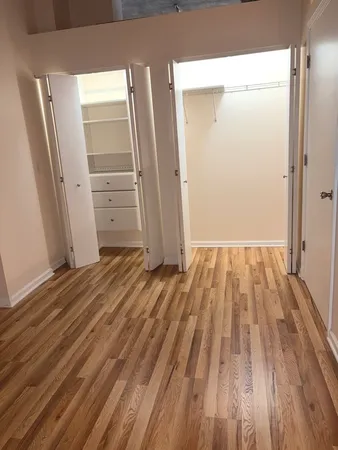 a view of a room with wooden floor and electronic appliances