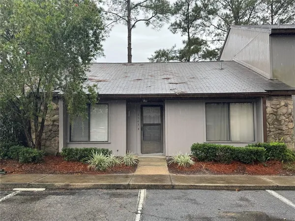 a house that has a tree in front of it