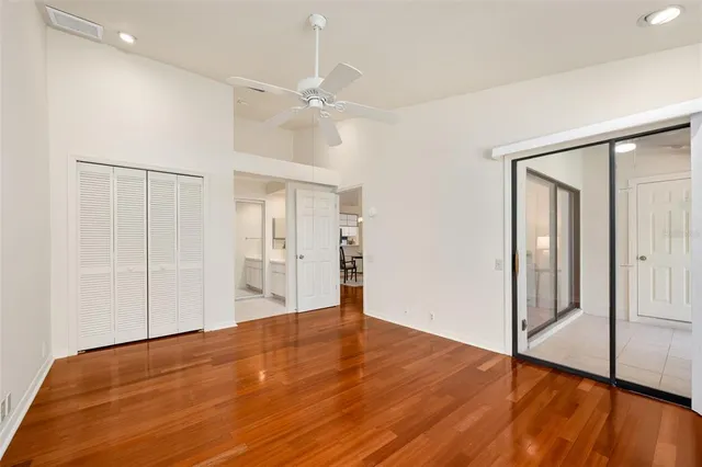 a view of empty room with wooden floor