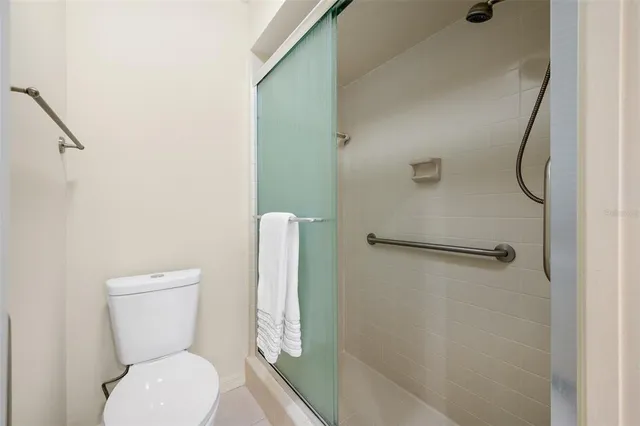 a bathroom with a toilet a sink and a shower