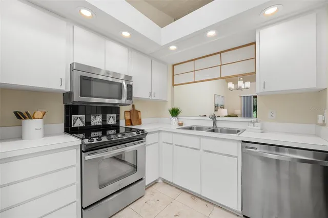 a kitchen with a sink stove and microwave