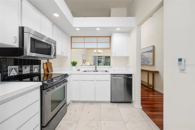a kitchen with a sink stove and refrigerator