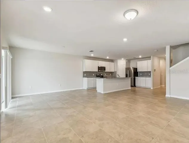 a view of kitchen with refrigerator sink and stove