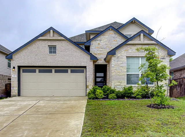 a front view of house with garage and yard