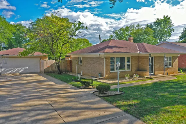 a patio with a table and chairs and a barbeque