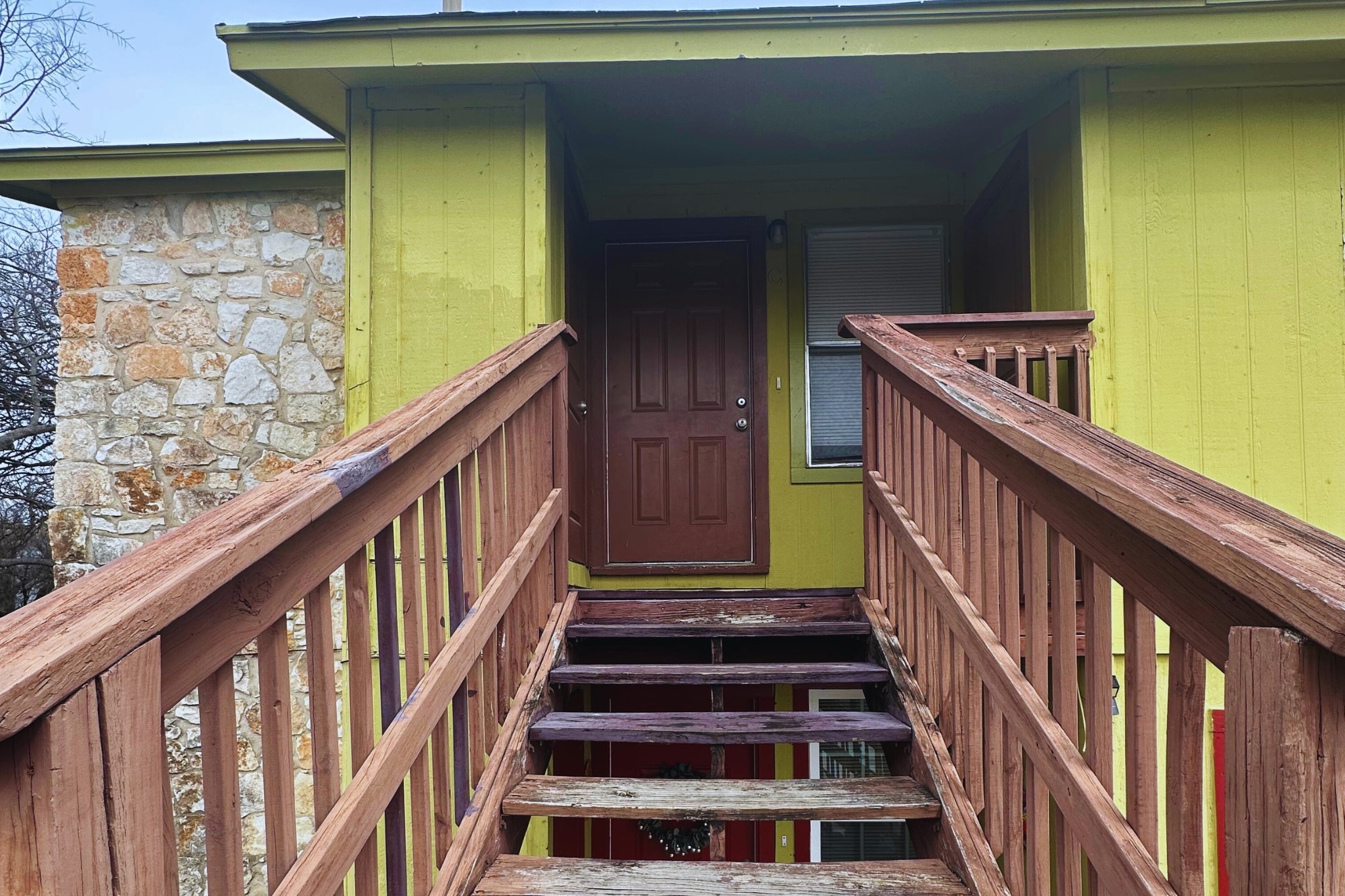 View of exterior entry with stone siding